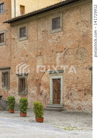 Ancient brick building in Piazza del Duomo San Miniato Ancient brick building in Piazza del Duomo San Miniato 141729912