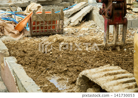 Debris and excavators on the site of a house where demolition work is underway. Debris and excavators on the site of a house where demolition work is underway. 141730053