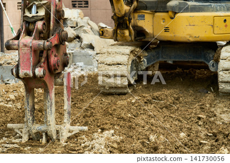 Debris and excavators on the site of a house where demolition work is underway. Debris and excavators on the site of a house where demolition work is underway. 141730056