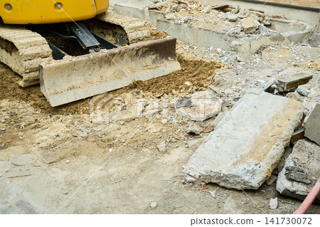Debris and excavators on the site of a house where demolition work is underway. Debris and excavators on the site of a house where demolition work is underway. 141730072