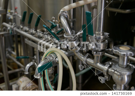 Piping and valves in a brewery: A close-up of brewing equipment. Piping and valves in a brewery: A close-up of brewing equipment. 141730169