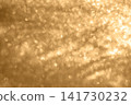 Soft golden bokeh background with sparkling glitter texture and warm light abstract 141730232