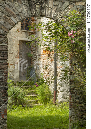 Stone archway leading to overgrown steps and old door in Garessio, Piedmont Stone archway leading to overgrown steps and old door in Garessio, Piedmont 141730307
