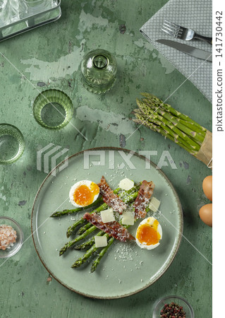 Asparagus plate with bacon, soft boiled eggs, and parmesan 141730442
