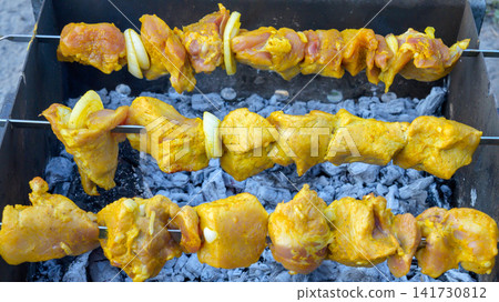 marinated raw meat kebab on skewers over hot coals in barbecue grill marinated raw meat kebab on skewers over hot coals in barbecue grill 141730812