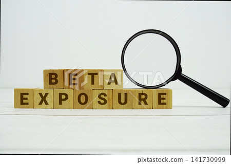 BETA EXPOSURE alphabet letters with magnifying glass on wooden background BETA EXPOSURE alphabet letters with magnifying glass on wooden background 141730999