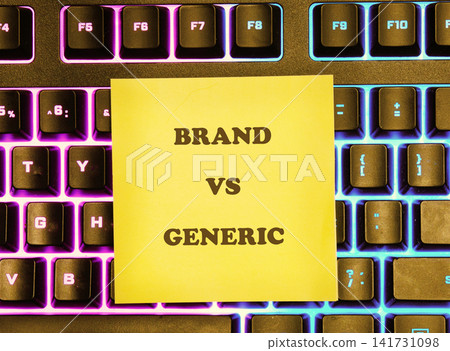 A bright sticky note is placed on a computer keyboard. The note shows the words brand and generic. The keyboard has a colorful light shining from it A bright sticky note is placed on a computer keyboard. The note shows the words brand and generic. The keyboard has a colorful light shining from it 141731098
