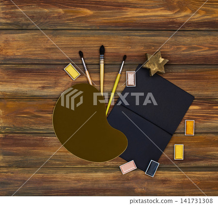 Table of an artist and empty copy space. View from above. creative colorful golden art supplies. Goods for creativity. Table of an artist and empty copy space. View from above. creative colorful golden art supplies. Goods for creativity. 141731308