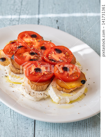 Elegant Caprese salad with mozzarella tomatoes king oyster mushrooms balsamic olive oil appetizer platter Elegant Caprese salad with mozzarella tomatoes king oyster mushrooms balsamic olive oil appetizer platter 141731361