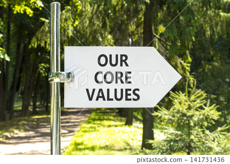 Our core values words symbol. Concept words Our core values on beautiful white road sign. Beautiful green forest garden background. Business our core values motivational support concept. Copy space. Our core values words symbol. Concept words Our core values on beautiful white road sign. Beautiful green forest garden background. Business our core values motivational support concept. Copy space. 141731436