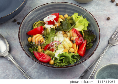 Healthy vegetarian pasta salad with chickpeas and tomatoes Healthy vegetarian pasta salad with chickpeas and tomatoes 141731961