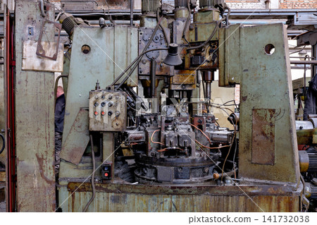 Heavy Industrial Rotary Indexing Machine with Control Panel in Old Factory Workshop Heavy Industrial Rotary Indexing Machine with Control Panel in Old Factory Workshop 141732038