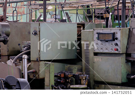 Old green industrial machine control panel with buttons display screen and electrical cabinet in factory Old green industrial machine control panel with buttons display screen and electrical cabinet in factory 141732051
