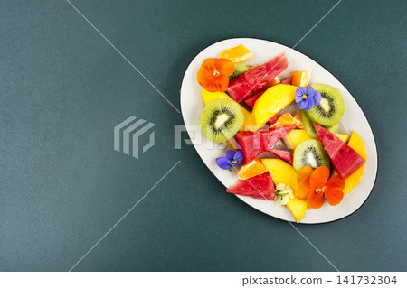 Fresh Summer Fruit Salad with Edible Flowers and Tropical F 141732304