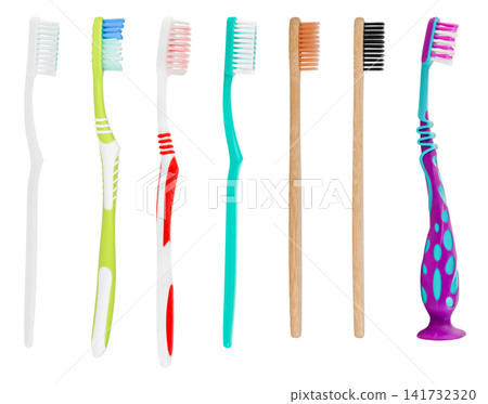 Row of various plastic and bamboo toothbrushes isolated on white background Row of various plastic and bamboo toothbrushes isolated on white background 141732320