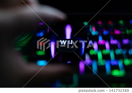 Close-up of a finger pressing W key on a colorful RGB backlit keyboard, illustrating computer interaction, gaming, typing, digital workflow and modern technology concepts Close-up of a finger pressing W key on a colorful RGB backlit keyboard, illustrating computer interaction, gaming, typing, digital workflow and modern technology concepts 141732389