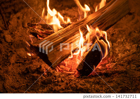 The firewood burns brightly in the hearth. The firewood burns brightly in the hearth. 141732711