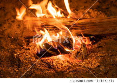 The firewood burns brightly in the hearth. The firewood burns brightly in the hearth. 141732715