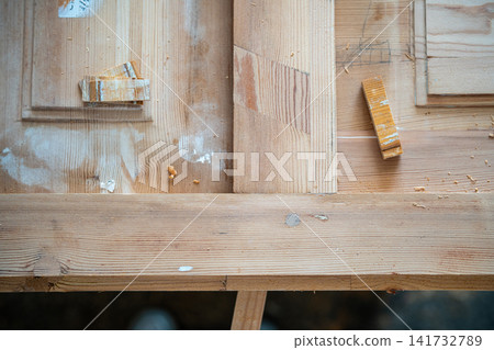Surface of wooden door with dowels, restoration process of door reconstruction in woodworking shop. Surface of wooden door with dowels, restoration process of door reconstruction in woodworking shop. 141732789