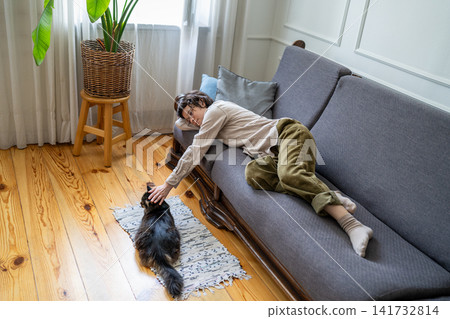 Boredom, procrastination and laziness, peaceful idle woman lying resting on couch at home during day Boredom, procrastination and laziness, peaceful idle woman lying resting on couch at home during day 141732814