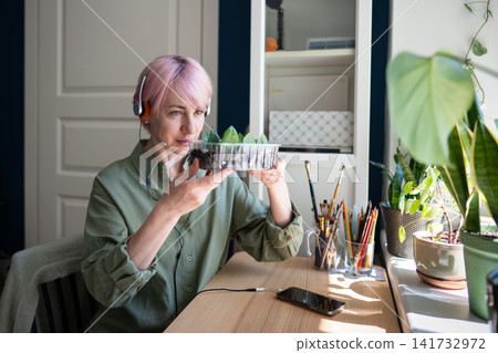 Happy mature woman enjoying slow living at home on weekend and devoting free time to favorite hobby Happy mature woman enjoying slow living at home on weekend and devoting free time to favorite hobby 141732972
