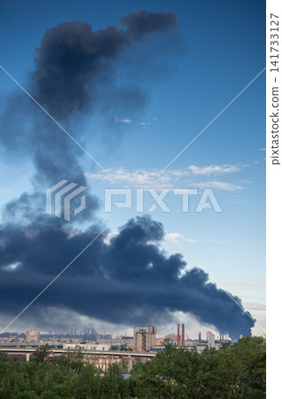 Major fire at oil refinery production facility with thick smoke rising from industrial area Major fire at oil refinery production facility with thick smoke rising from industrial area 141733127