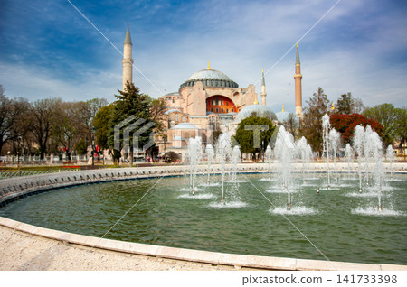 The large fountain of Sultanahmet Square in front of the domes and minarets of Hagia Sophia in Istanbul, Turkey, a popular tourist landmark. The large fountain of Sultanahmet Square in front of the domes and minarets of Hagia Sophia in Istanbul, Turkey, a popular tourist landmark. 141733398