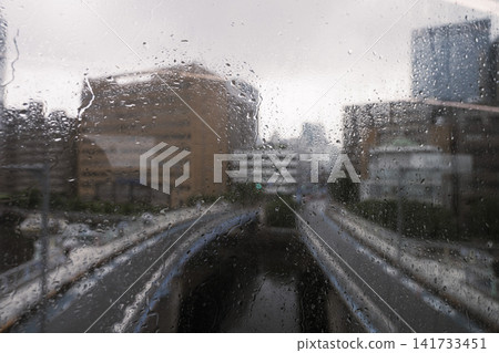 Rainy City Street Through Wet Window Rainy City Street Through Wet Window 141733451