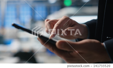 Building contractor managing solar production line in a high tech facility, ensuring sustainability and efficiency in photovoltaics manufacturing systems. Corporate oversight. Camera B. 141733520