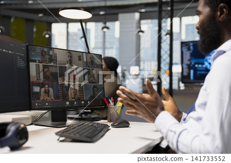 Developer doing internet videocall with team, adjusting deep learning algorithms parameters to automate tasks. Tech company employees in teleconference meeting discussing AI driven insights Developer doing internet videocall with team, adjusting deep learning algorithms parameters to automate tasks. Tech company employees in teleconference meeting discussing AI driven insights 141733552