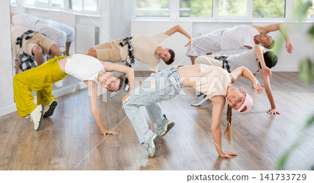 Teenage girl dancing breakdancing in group 141733729