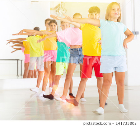 Children primary school age rehearsing movements of ballet dance in modern studio 141733802