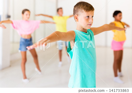Young girls and boys performing dance in studio Young girls and boys performing dance in studio 141733863