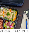 Flat lay of healthy meal prep lunch with chicken breast, vegetables, brown rice and salad for clean eating lifestyle. 141733933