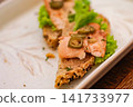 Close-up of a smoked salmon open sandwich with lettuce and jalapeno on seeded bread, served on a white plate. Elegant gourmet food concept. 141733977