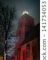 Illuminated Tower Between Narrow Old Town Streets at Night 141734053