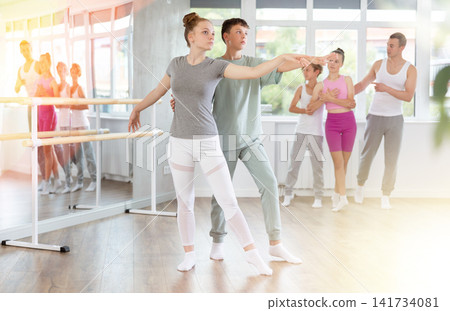 Ballet training for teenagers in a ballet studio under the guidance of choreographer Ballet training for teenagers in a ballet studio under the guidance of choreographer 141734081