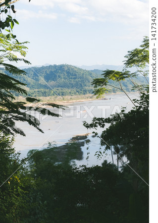 The Mekong River flows between Thailand and Laos. The Mekong River flows between Thailand and Laos. 141734200