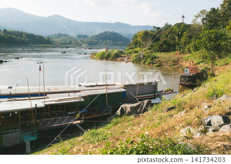 The Mekong River flows between Thailand and Laos. The Mekong River flows between Thailand and Laos. 141734203