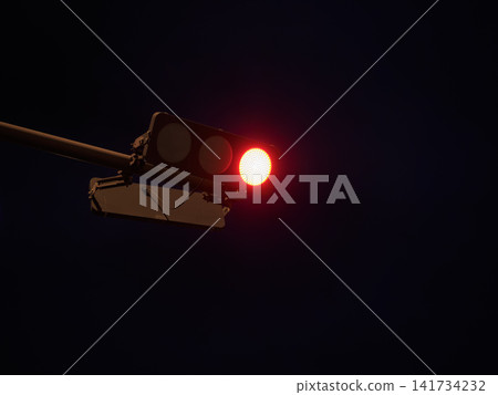 Red lights illuminate the night sky; traffic signals symbolize traffic safety. Red lights illuminate the night sky; traffic signals symbolize traffic safety. 141734232