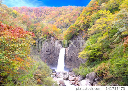 The Naena Falls, roaring down amidst the vibrant autumn foliage, 141735473