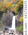The water of Naena Falls, one of Japan's Top 100 Waterfalls, surrounded by autumn foliage, falls into the waterfall basin. 141735475