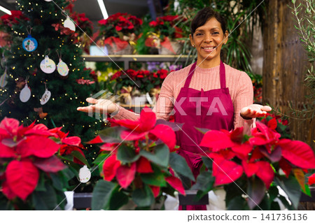 Woman owner flower shop with christmas flower Woman owner flower shop with christmas flower 141736136