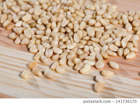 Picture of raw pine nut on the wooden desk, nobody Picture of raw pine nut on the wooden desk, nobody 141736170