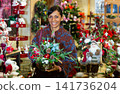 Hispanic woman in decorative goods store in new year's eve 141736204