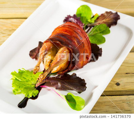 Baked in bacon quail with balsamic sauce is tasty dish Baked in bacon quail with balsamic sauce is tasty dish 141736370