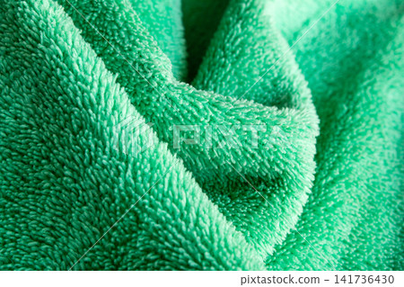 Green Microfiber Fabric Texture Abstract Background with Soft Folds Green Microfiber Fabric Texture Abstract Background with Soft Folds 141736430