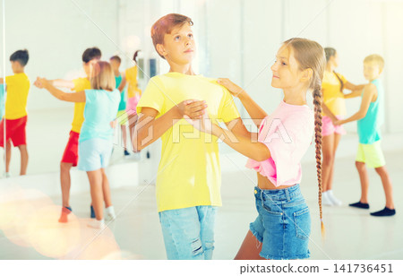 Kids dancing waltz in studio Kids dancing waltz in studio 141736451