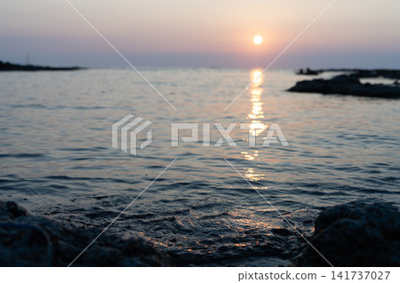 The sunset and twilight scenery coloring the beach at dusk. The sunset and twilight scenery coloring the beach at dusk. 141737027