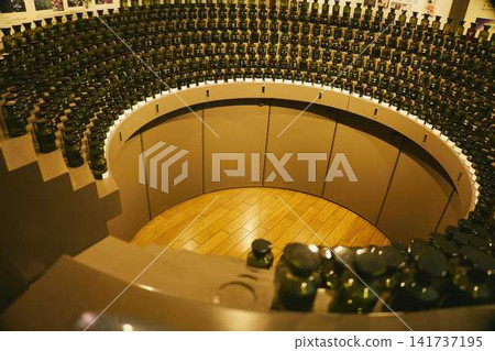 A row of green, light-blocking bottles arranged in a circle at the Perfume Museum in Beppu. A row of green, light-blocking bottles arranged in a circle at the Perfume Museum in Beppu. 141737195